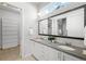 Bright bathroom featuring double sinks, white cabinetry, a large mirror, and plenty of counter space at 3598 New Haven Cir, Castle Rock, CO 80109