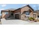 Beautiful home exterior featuring stone accents, wood siding, well-maintained landscaping, and a spacious driveway at 3598 New Haven Cir, Castle Rock, CO 80109
