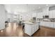 Spacious kitchen with white cabinets, stainless steel appliances, large island, and an open layout to dining at 3598 New Haven Cir, Castle Rock, CO 80109