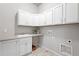 Efficient laundry room with upper and lower cabinets, sink, countertop, and utility hookups at 3598 New Haven Cir, Castle Rock, CO 80109