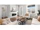 Bright living room with fireplace, built-in shelves, stylish furniture, and a large window at 3598 New Haven Cir, Castle Rock, CO 80109