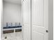 Convenient mudroom featuring a bench with pillows and a storage closet behind double doors at 3598 New Haven Cir, Castle Rock, CO 80109