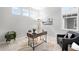 Bright office space featuring a modern desk, accent chair, and ample natural light from the large windows at 3598 New Haven Cir, Castle Rock, CO 80109