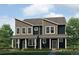 Contemporary two-story townhome featuring vertical siding, covered entry, and professionally landscaped front yard at 1397 S Chester St # B, Denver, CO 80247