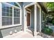 Townhome entrance with wooden door and gray siding at 2960 W Long Dr # E, Littleton, CO 80120