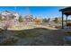 Expansive backyard with a mix of grass, rocks, and shrubs is ideal for outdoor activities and landscaping at 655 Tiger Lily Way, Highlands Ranch, CO 80126