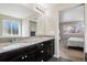 Spacious bathroom with double vanity, tile floor, and access to bedroom at 655 Tiger Lily Way, Highlands Ranch, CO 80126