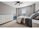 Bedroom with gray walls, neutral carpet, ceiling fan, and an adjacent writing desk at 655 Tiger Lily Way, Highlands Ranch, CO 80126