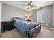 Comfortable bedroom featuring a ceiling fan and a rustic wood bed frame at 655 Tiger Lily Way, Highlands Ranch, CO 80126