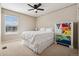 Bright bedroom with a large window and unique colorful dresser accents at 655 Tiger Lily Way, Highlands Ranch, CO 80126