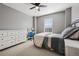 Comfortable bedroom with neutral walls, ceiling fan, and abundant natural light from the lovely window at 655 Tiger Lily Way, Highlands Ranch, CO 80126
