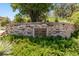 Elegant stone entrance sign surrounded by lush greenery, welcoming you to the beautiful Backcountry community at 655 Tiger Lily Way, Highlands Ranch, CO 80126