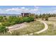 Exterior view of clubhouse with ample natural light, surrounded by landscaped lawns and mountain backdrop at 655 Tiger Lily Way, Highlands Ranch, CO 80126