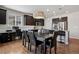 Stylish kitchen with an island, dark wood cabinets, granite countertops, stainless steel appliances, dining area and hardwood floors at 655 Tiger Lily Way, Highlands Ranch, CO 80126