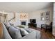 Inviting living room boasts a fireplace and a comfortable gray sectional couch at 655 Tiger Lily Way, Highlands Ranch, CO 80126