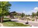 Landscaped gated community entrance with stone accents, lush greenery, and well-maintained roads at 655 Tiger Lily Way, Highlands Ranch, CO 80126