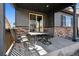 Cozy patio with outdoor seating, complemented by the home's stone accents and shaded ambiance at 655 Tiger Lily Way, Highlands Ranch, CO 80126