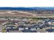 Stunning aerial view of a community nestled near rolling hills with majestic mountain views in the distance at 815 Alumroot St, Castle Rock, CO 80104
