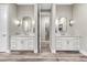 Bathroom featuring double vanities with quartz countertops, framed mirrors and stylish lighting fixtures at 815 Alumroot St, Castle Rock, CO 80104