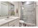 Bathroom with a quartz countertop and backsplash, and glass enclosed shower at 815 Alumroot St, Castle Rock, CO 80104