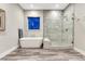 Bathroom featuring a freestanding tub and glass-enclosed shower with a tile surround and accent floor at 815 Alumroot St, Castle Rock, CO 80104