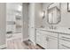 Bathroom featuring a vanity with a quartz countertop, modern lighting, and a walk-in closet at 815 Alumroot St, Castle Rock, CO 80104