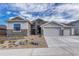 Inviting home exterior showcasing stone accents, gravel landscaping, and a well-maintained yard at 815 Alumroot St, Castle Rock, CO 80104