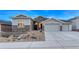 Well-lit home exterior with stone details, manicured landscaping, and a welcoming entrance at 815 Alumroot St, Castle Rock, CO 80104