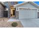 A charming home entrance with a stone facade, gravel landscaping, and well-maintained walkway at 815 Alumroot St, Castle Rock, CO 80104