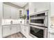 Kitchen appliances including double oven, white cabinets and granite counters at 815 Alumroot St, Castle Rock, CO 80104