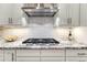 Gas cooktop, granite counters and bright white cabinets in a gourmet kitchen at 815 Alumroot St, Castle Rock, CO 80104