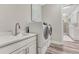Well-equipped laundry room featuring modern appliances, a sink with quartz countertop, and abundant storage space at 815 Alumroot St, Castle Rock, CO 80104
