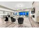 Bright, open living room with a fireplace, modern lighting, and seamless access to the kitchen at 815 Alumroot St, Castle Rock, CO 80104
