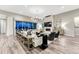 Open-concept living room with a fireplace, modern chandelier, and sliding glass doors to the outside at 815 Alumroot St, Castle Rock, CO 80104