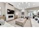 Spacious living room with a fireplace, modern lighting, and stylish furniture at 815 Alumroot St, Castle Rock, CO 80104