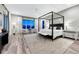 Spacious main bedroom featuring a four-poster bed, seating area, and large windows with scenic views at 815 Alumroot St, Castle Rock, CO 80104