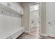 Bright mudroom with a bench, storage cabinets, and easy access to the laundry room with modern washer and dryer at 815 Alumroot St, Castle Rock, CO 80104