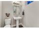 Powder room featuring a pedestal sink, modern faucet, and framed mirror at 815 Alumroot St, Castle Rock, CO 80104