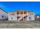 Back exterior of a home featuring a spacious covered deck and patio for outdoor relaxation and entertainment at 815 Alumroot St, Castle Rock, CO 80104