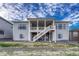 Lovely back exterior showcasing a covered deck and patio, ideal for outdoor living and enjoying the property's surroundings at 815 Alumroot St, Castle Rock, CO 80104
