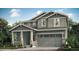 Charming two-story home featuring a covered porch and attached two-car garage at 175 Fremont Ct, Brighton, CO 80601