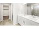 Bathroom featuring a double sink vanity and a walk-in closet at 8840 Sedalia St, Commerce City, CO 80022