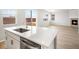 Eat-in kitchen with quartz counters, stainless appliances, and hardwood flooring at 8840 Sedalia St, Commerce City, CO 80022