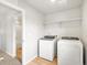 Laundry room featuring modern appliances and a storage shelf at 8840 Sedalia St, Commerce City, CO 80022