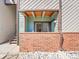 Covered balcony with brick wall and stairs leading to other condos at 11985 E Harvard Ave # 108, Aurora, CO 80014