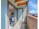 Private balcony offers outdoor seating, brick accents and a sliding glass door to the home's interior at 11985 E Harvard Ave # 108, Aurora, CO 80014