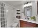 Updated bathroom featuring a modern vanity, sleek fixtures, and a combined shower and bathtub at 11985 E Harvard Ave # 108, Aurora, CO 80014