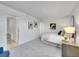 Relaxing bedroom featuring carpet, a comfortable bed, and ample closet space at 11985 E Harvard Ave # 108, Aurora, CO 80014