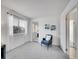 Cozy bedroom with carpet, a comfortable chair, and serene natural lighting at 11985 E Harvard Ave # 108, Aurora, CO 80014