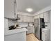 Bright kitchen with white cabinets, modern appliances, and minimalist design at 11985 E Harvard Ave # 108, Aurora, CO 80014